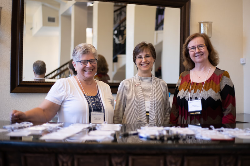 3 women working at registration area - Peggy Lindsay, Larisa Brown, Kathy Smith