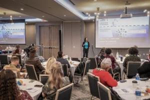 a speaker talks with the attendees of the 2025 summit